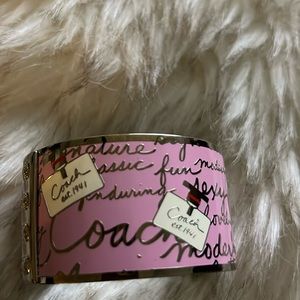 Authentic Coach bangle. 2 in silver and pink with classic perfume bottle art.
